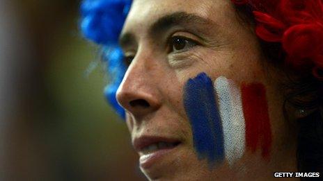 Woman with French flag painted on her face