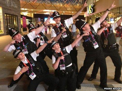Police officers struck a Usain Bolt pose