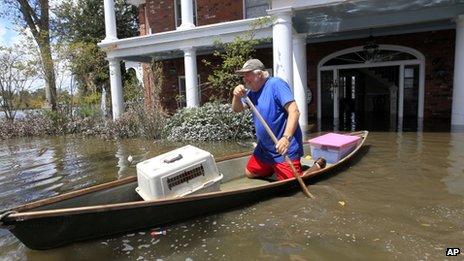 Don Duplantier paddles a pirogue from his flooded home as floodwaters from Hurricane Isaac recede in Braithwaite, Louisiana, on 2 September 2012