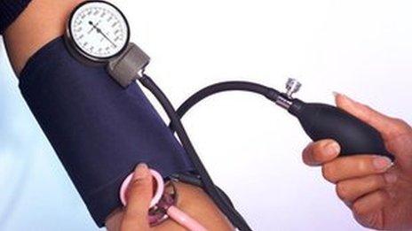 Doctor taking blood pressure