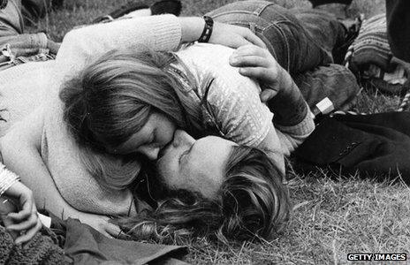 Couple kissing at 1960s festival in Hyde Park
