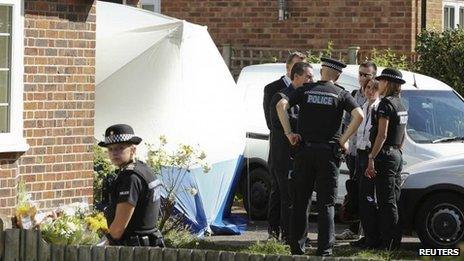 French police speak to their British counterparts outside the home of Saad al-Hilli in Surrey