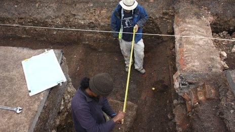 Archaeologists recording the grave