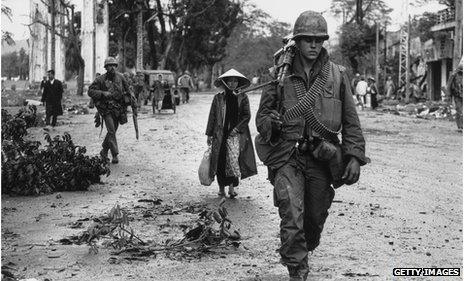 American soldiers and Vietnamese refugees returning to the town of Hue, in Vietnam