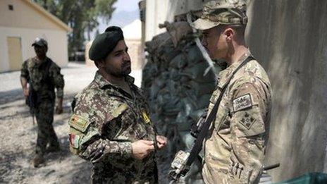 A Afghan officer from the 2nd Kandak, 2nd Brigade, 201st corps of the Afghan National Army and an officer of the 4th brigade combat team 4th infantry division of the U.S. Army talk at Forward Operating Base Joyce, in Kunar