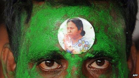 a sticker bearing a portrait of Trinamool Congress (TMC) Leader Mamata Banerjee is seen on the forehead of a supporter outside a counting centre in Kolkata