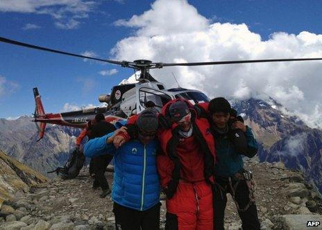 Nepalese rescuers help a foreigner injured on Mount Manaslu, 23 September