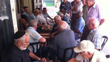 Retired men playing backgammon in Mahane Yehuda market, Jerusalem