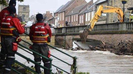 Debris is cleared from a bridge in Morpeth