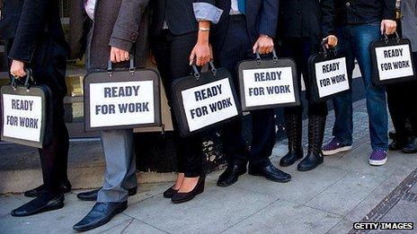 Students hold brief cases labelled 'ready to work'