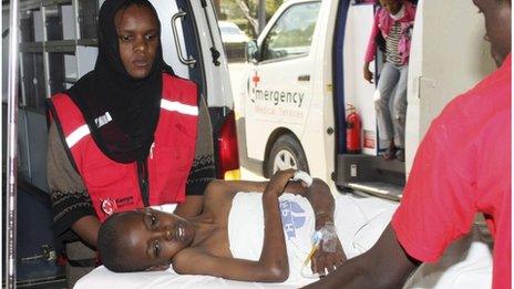 Kenya Red Cross personnel assist a child injured during an explosion at the Anglican Church of Kenya in Nairobi, September 30