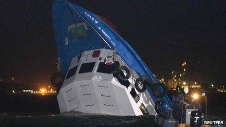 Rescuers approach a partially-submerged boat after two vessels collided off Hong Kong on 1 October 2012