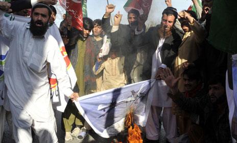 Islamabad protesters burn picture of drone