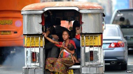 Homeless mother with child on a jeepney in Manila (Dec 20110