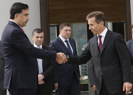 Mikheil Saakashvili (left) shakes hands with Bidzina Ivanishvili in Tbilisi, 9 October