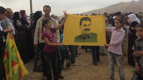 PKK supporters hold up banner of imprisoned PKK leader Abdullah Ocalan