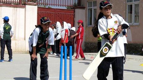 Schoolgirls playing cricket