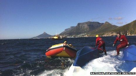NSRI volunteers on the capsized hull of the charter boat off Cape Town