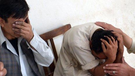 Shias mourn the killing of their relatives at a hospital following the attack by gunmen in Quetta
