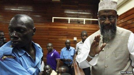 Kenyan Member of Parliament Sheikh Mohammed Dor (R) is escorted to the court cells after denying incitement charges levelled against him when he addressed supporters of separatist Muslim Mombasa Republican Council (MRC), in the coastal port city Mombasa October 18, 2012.