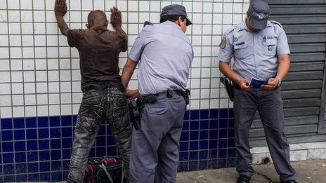 Military policemen frisk a suspect in downtown Sao Paulo