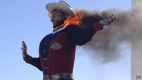 Fire begins to engulf the Big Tex displayed at the State Fair of Texas in Dallas 19 October 2012