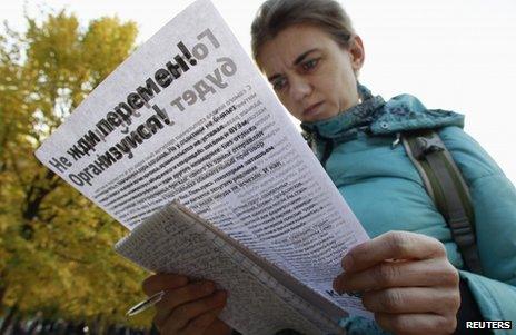 A woman scrutinises an information leaflet at an opposition voting point in Moscow, 20 October