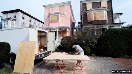 A resident of New Jersey boards up in preparation for Hurricane Sandy, 27 Oct