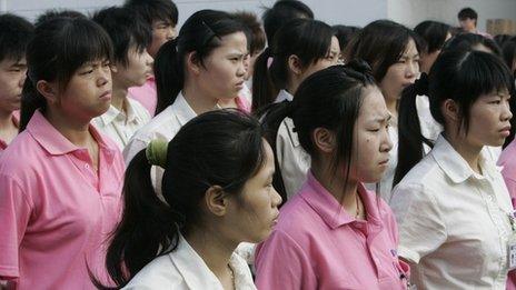 Chinese workers gather for a morning briefing session by the management at a factory in Foshan, southern China's Guangdong province on June 18, 2010