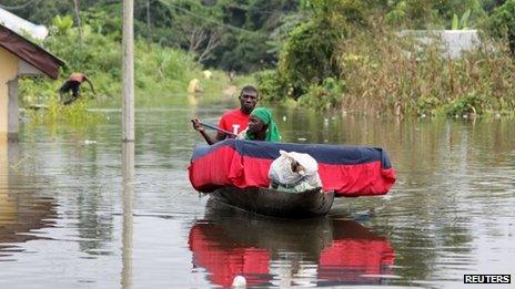 A man and his wife paddle a canoe with their belongings after flooding in the Amassoma community in Bayelsa state October 5, 2012.