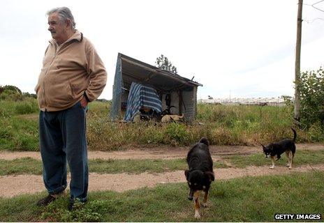 Jose Mujica and his dogs outside his home