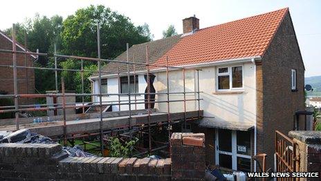 Rescue services in Wales cut into to the top floor of a house to rescue a young obese woman