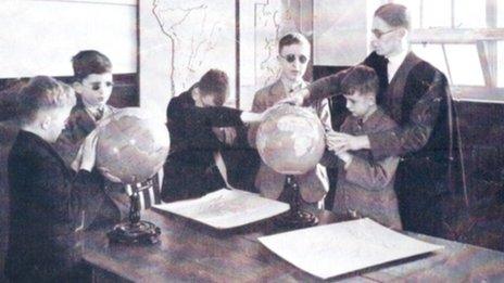 Pupils use braille world globes in geography