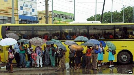 Commuters at Jamaican bus stop, 23 Oct 2012