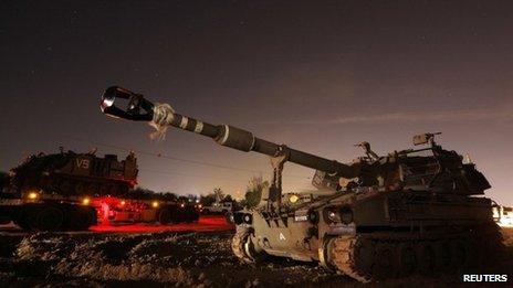 A 155mm mobile cannon (front) is seen after it was transported to an area just outside the northern Gaza Strip late on 15 November 2012