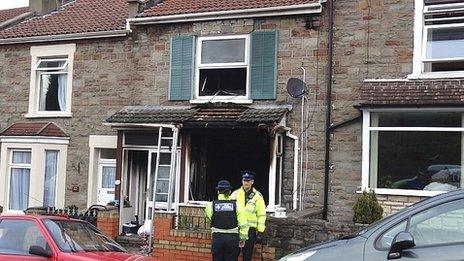 Police Community Support Officers outside a house in Cossham, Bristol