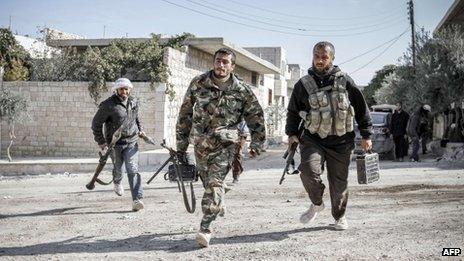 Rebels defending the town run towards a forward fighting position in Maraat al-Numan November 20, 2012