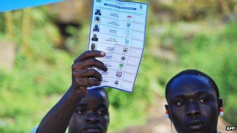 An election scrutiniser counts a ballot at a polling station in Freetown, Sierra Leone, on 17 November 2012