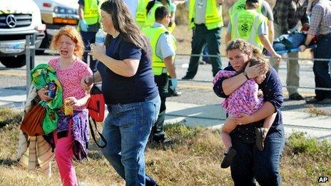 A family walks away from the pile-up on Interstate 10 in Texas on 22 November 2012