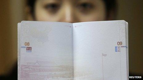 A woman holds the new Chinese passport on 23 November 2012