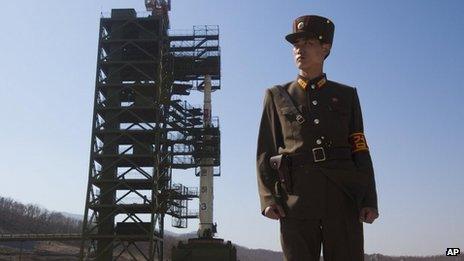 n this April 8, 2012 file photo, a North Korean soldier stands in front of the country's Unha-3 rocket, slated for liftoff between April 12-16, at Sohae Satellite Station in Tongchang-ri, North Korea