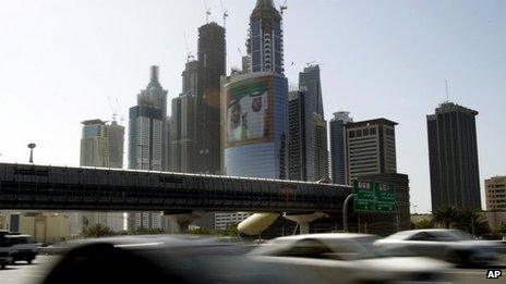 Cars pass by a picture of the prime minister and president of the UAE at Internet City in Dubai (file)