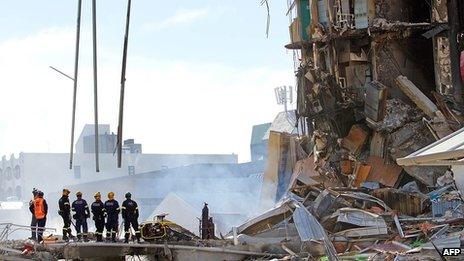 Rescuers at the smoking ruins of the CTV building on 24 February 2011
