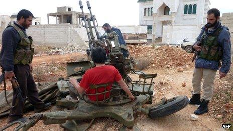 Rebel fighters man an anti-aircraft gun in Base 111 at Sheikh Suleiman (09 December 2012)