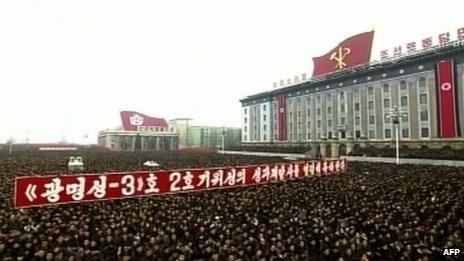 North Koreans attending a mass rally organised to celebrate the success of a rocket launch that sent a satellite into space, Kim Il-sung Square, Pyongyang, North Korea, 14 December 2012
