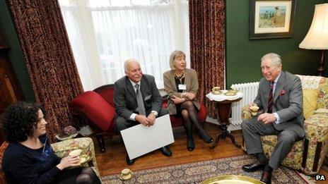 Prince Charles in the living room of the birthplace of Dylan Thomas in Swansea with (left to right) granddaughter of Dylan Thomas, Hannah Ellis Thomas, and restorers of the house Geoff Haden and Anne Haden