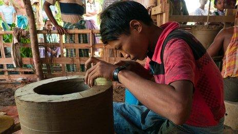 A man makes a stove in the Irrawaddy Delta