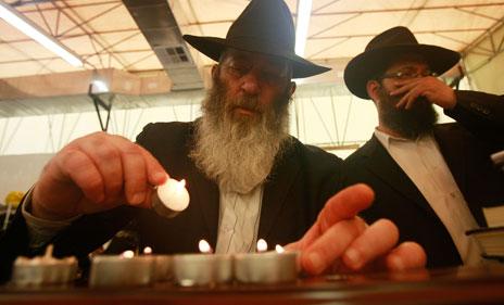 Lubavitch Hassidic Jews in New York light candles on the anniversary of the death of their leader