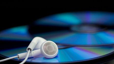 Stock image of earphones and CDs