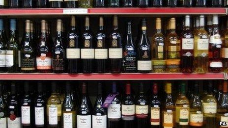 Rows of bottle on supermarket shelf